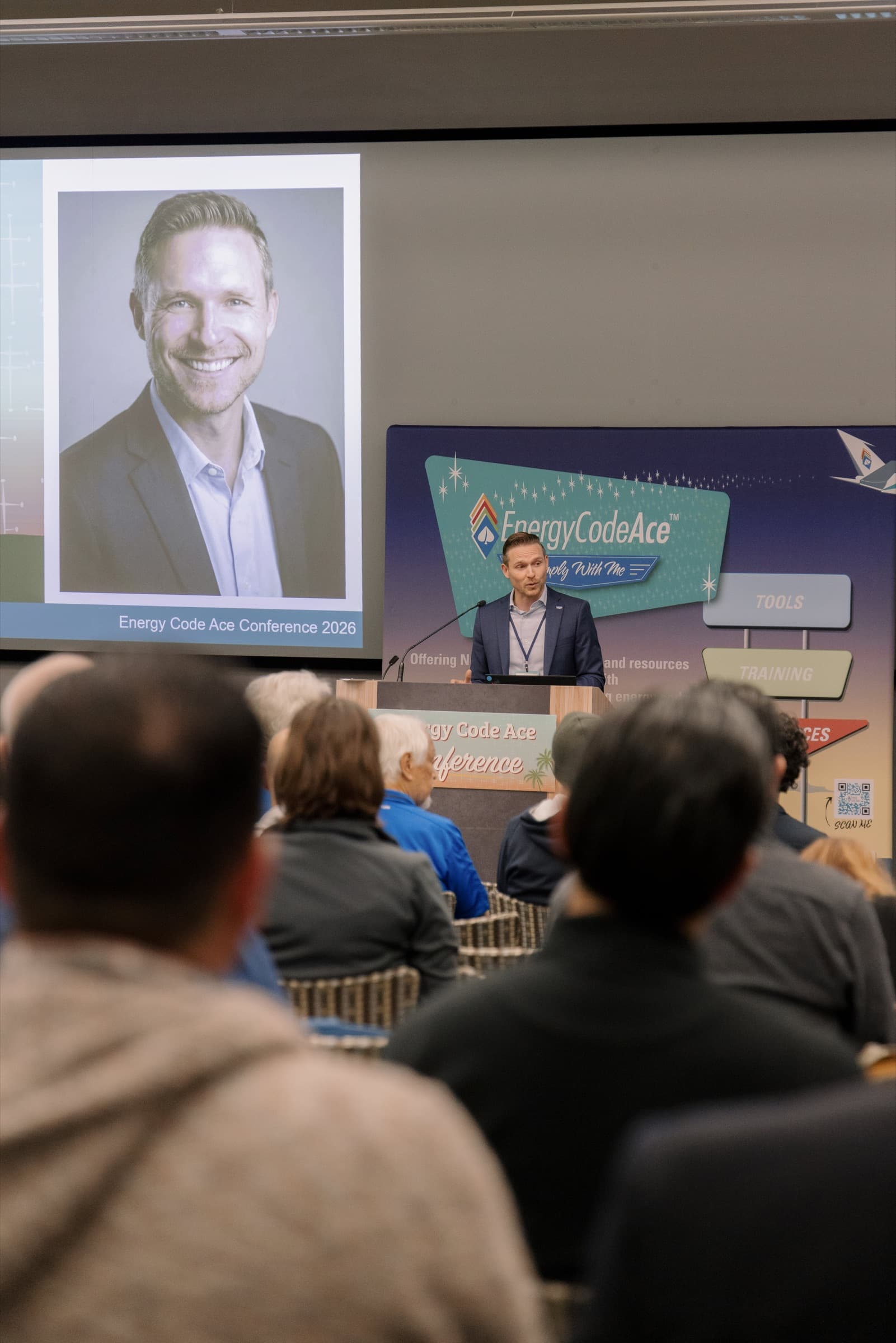 A speaker at the Energy Code Ace Conference, seen from the audience